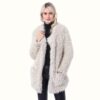 White Teddy Fur Coat Front view with one hand in pocket and one hand on collar